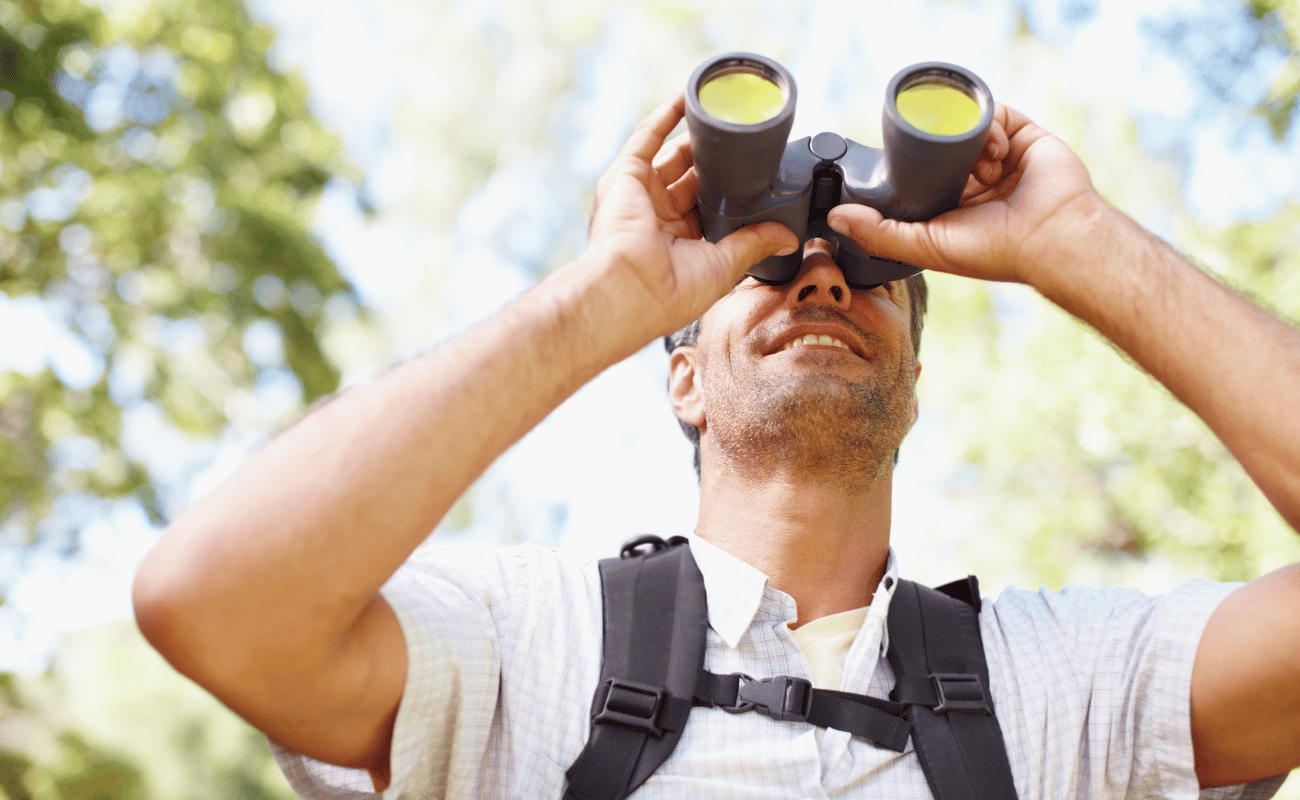 Tourist spotting wildlife with binoculars