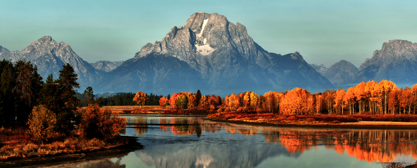 tetons and fall colors reflecting in water