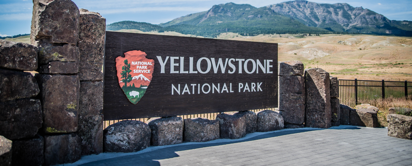 Yellowstone national park sign with panoramic view